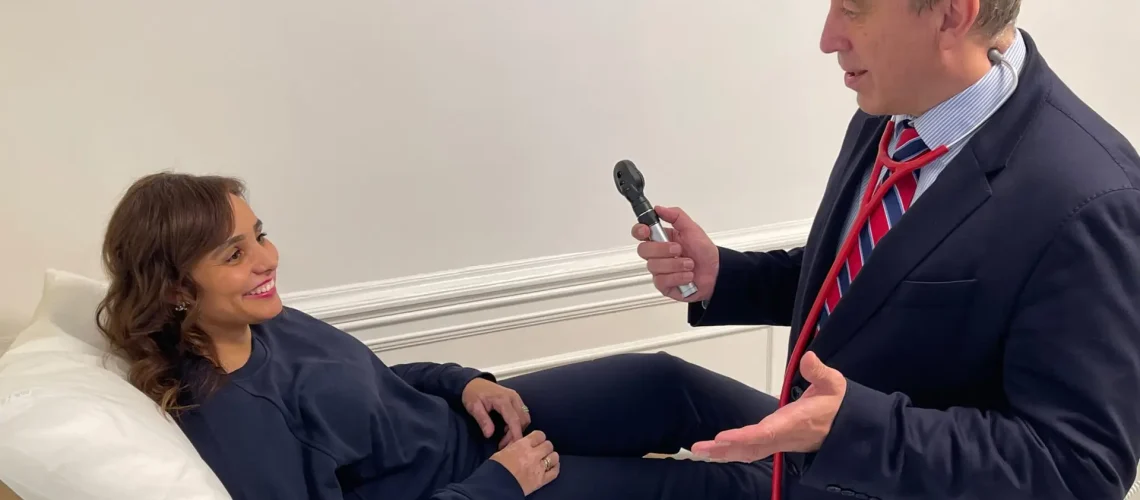 Dr garry savin conducting a consultation with a female patient at Lumen harley street clinic